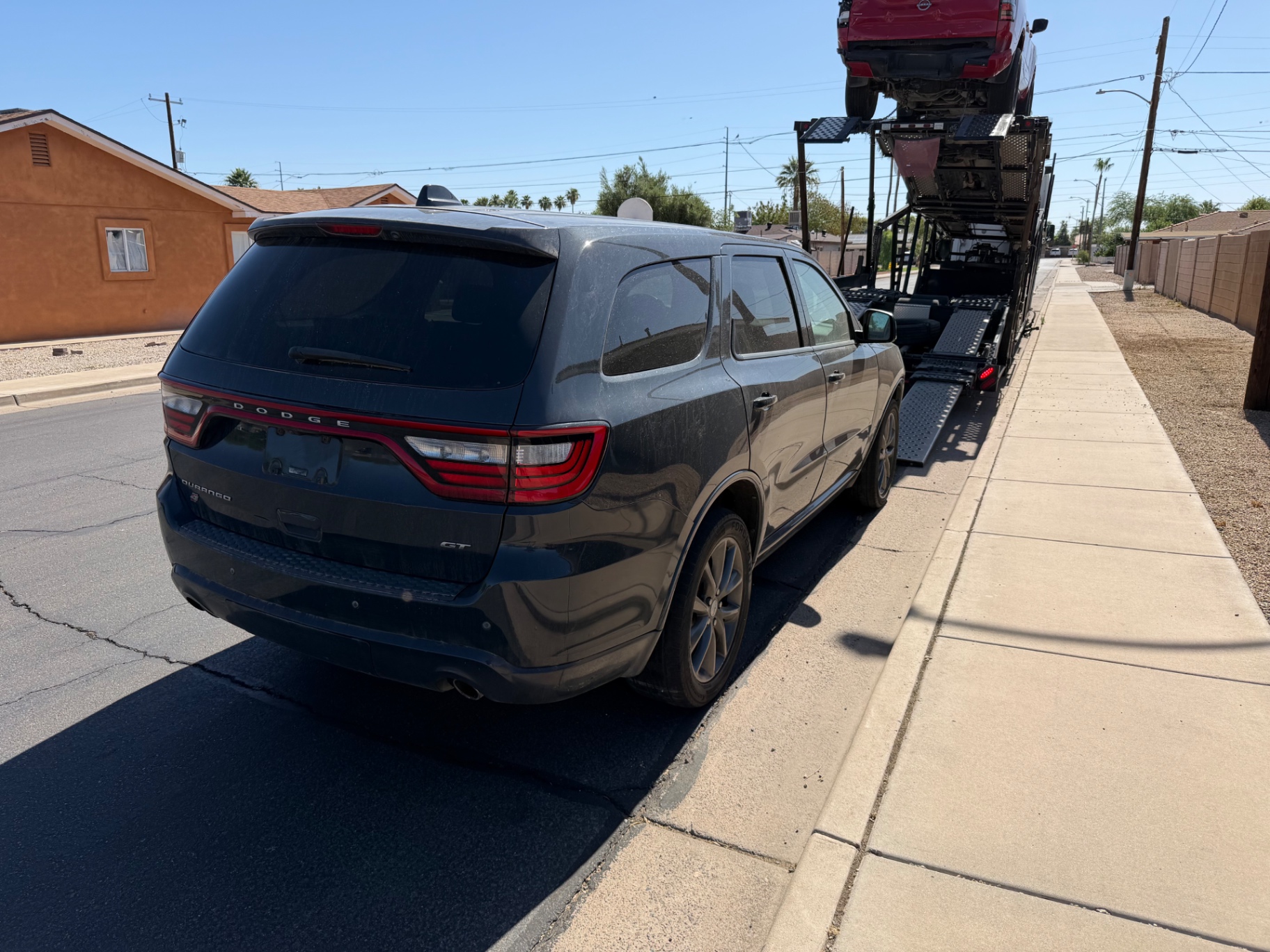 Dodge Durango beside the loading ramps of a car-hauling trailer