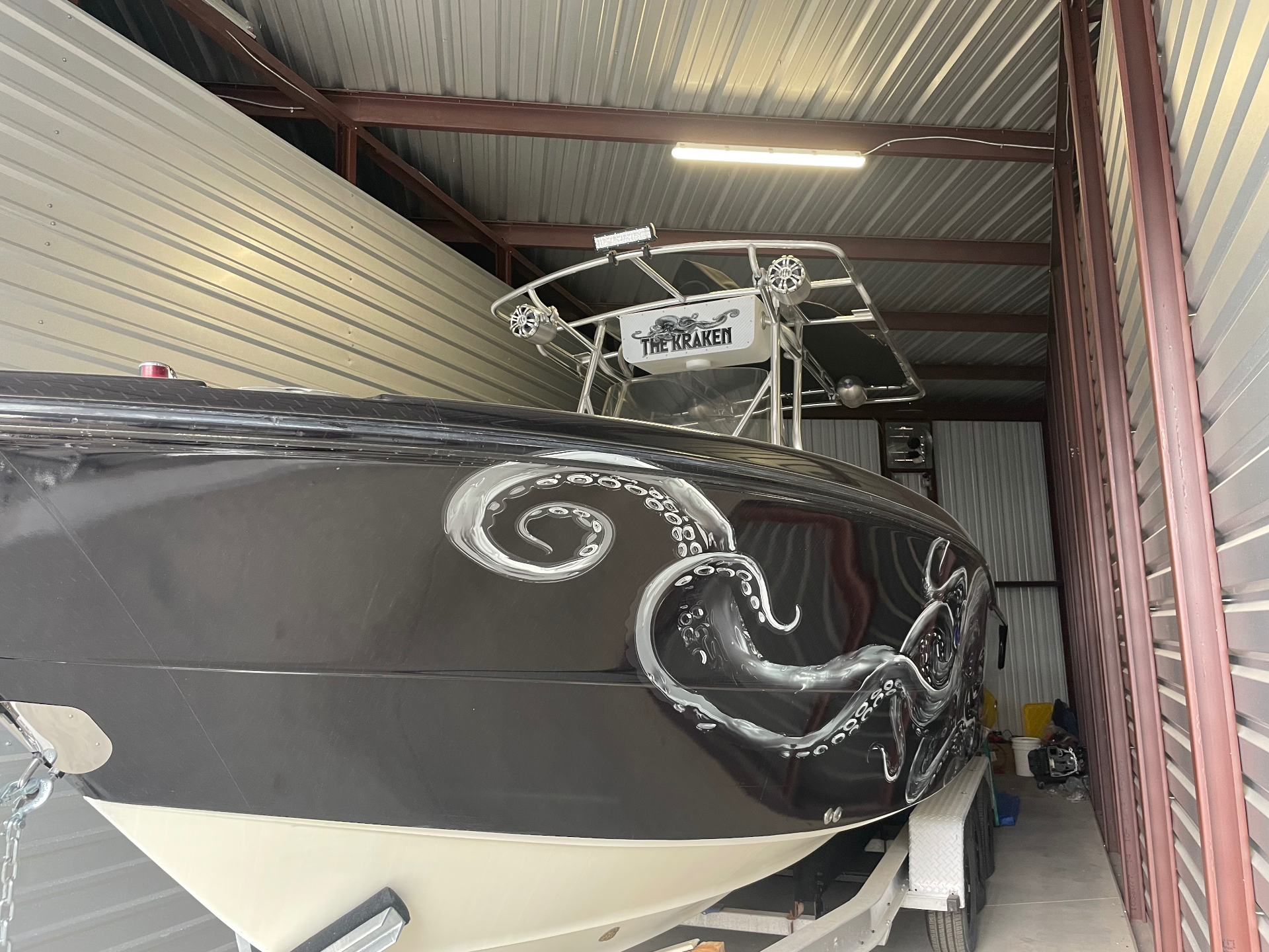 The Kraken boat resting on its trailer inside a storage building